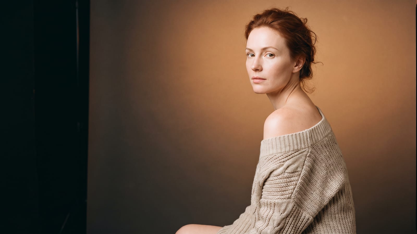 Woman in autumn knitwear with smooth, un-tanned skin, starting a laser hair removal course in fall at a Highland Park med spa