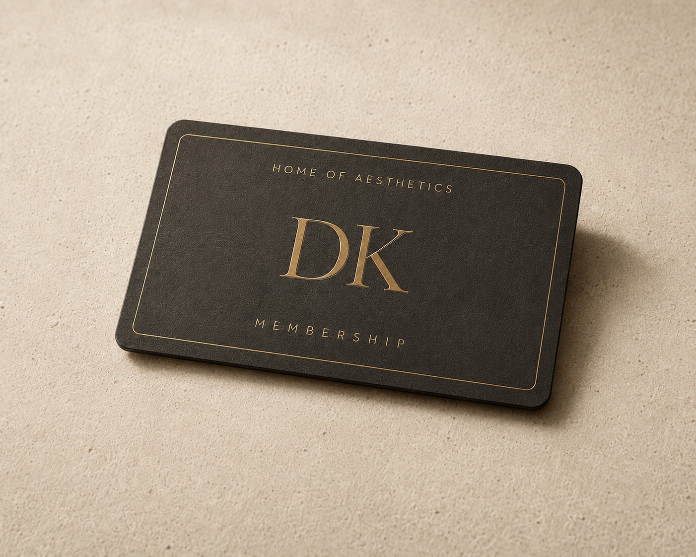 A charcoal card with gold lettering reading DK Home of Aesthetics Membership